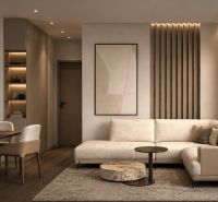 Living room in a holiday apartment with a sofa and wood-patterned flooring.
