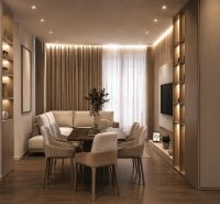 Interior of a holiday apartment with comfortable seating, a dining table, and a wooden decor floor.