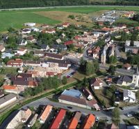 Aerial view of the village Budča with the layout of production facilities and surrounding greenery.