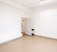White walls, light ceramic floor, open doors in commercial premises.