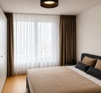 Bedroom with a large bed, built-in wardrobes, and a wooden decor floor in a 3-room apartment.