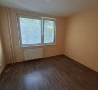 A room in a 3-room apartment with a wooden decor floor and a large window.