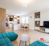 Living room with kitchen in a family house, floor with wood decor, staircase.