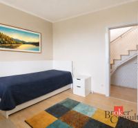 Children's room in a family house with simple furniture and a wooden decor floor.