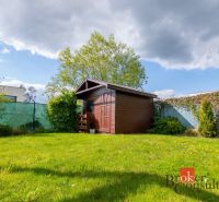 The garden of a family house on Kapsohradská in Bratislava-Záhorská Bystrica with a wooden shelter.