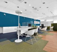 Workspace with chairs, white furniture, and wood-patterned flooring.