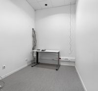 Office room with a simple desk, cables and sockets on the wall, commercial premises.