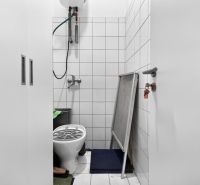 A small room in commercial premises, with a toilet and storage space.