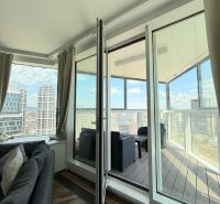 Living room with a sofa and access to a balcony in a 3-room apartment with a view.