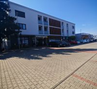 The building on Senická Street in Rohožník with parking spaces in the foreground.