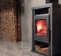 A family house with a wood-burning stove and a stone-patterned floor.