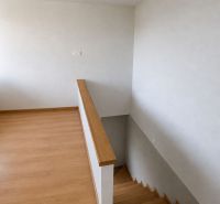 A floor with a wooden decor and stairs in a family house.