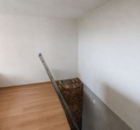 Family house: ladder, wooden decor flooring, stacked wood, white walls.
