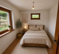 Bedroom in a family house with a bed, drawing on the wall, and a floor with a wooden decor.