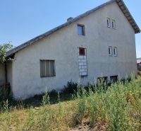 A family house on Biela Street in Kazimír surrounded by greenery under a blue sky.