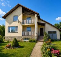 A family house on Biela Street in Kazimír, surrounded by a garden and flowers.