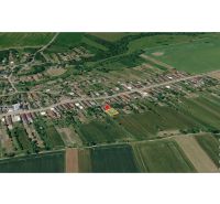 Aerial view of family houses in the village of Kazimír on Biela Street surrounded by fields.