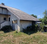 A family house on Biela Street in Kazimír with a simple facade and an overgrown plot.