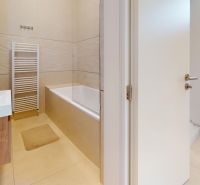 Bathroom with a bathtub, sink, and ladder radiator in a 3-room apartment.