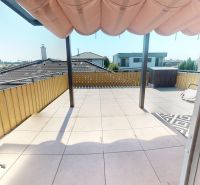 Terrace of a 3-room apartment with tiles and a view of the roofs and gardens in Biely Kostol on Okružná Street.