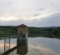 A reservoir amidst agricultural and forest lands in Kučišdorf Valley near Pezinok.