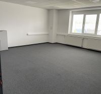Offices with carpet, white walls, and windows with blinds.
