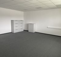 Empty office space with white furniture and gray carpet.