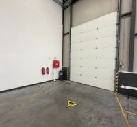In the interior of warehouses and halls, a white wall and safety features are visible.