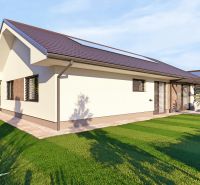 A family house in Tuchyňa surrounded by a green lawn and a garden terrace.