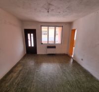 An empty room with a wooden floor in a family house.