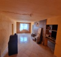 Living room in a family house with a tiled floor and a skylight.