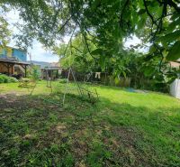 The garden at the family house on Šípošova Street in Šahy with a swing and trees.