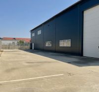 Warehouses and halls on Cementárenská Street in Stupava with paved areas and industrial gates.