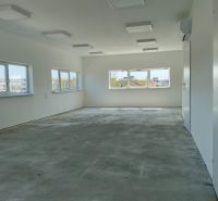 Interiors in warehouses and halls with windows and gray floors.