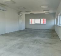 Interior with air conditioning units and large windows suitable for warehouses and halls.