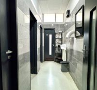 Interior of commercial spaces with white walls and plastic flooring in neutral tones.
