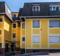 Yellow apartment building with a dark roof on Babenbergerstraße in Hainburg an der Donau.