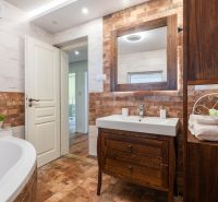 A bathroom with stylish tiles and wooden furniture in a 4-room apartment.