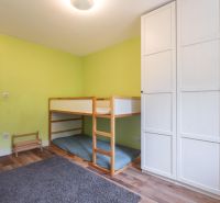 Children's room in a 4-room apartment with a bunk bed and a wardrobe, floor with wooden decor.
