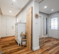 A hallway in a 4-room apartment with a wooden decor floor and storage spaces.