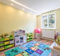 Children's room with toys and a wooden decor floor in a 4-room apartment.