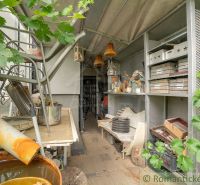 A garden at the cottage in Senec with numerous storage boxes and vine leaves.