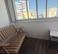 A furnished balcony with doors from a 2-room apartment overlooking Kresánkova Street.