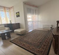 Living room with a sofa set, table, and wooden decor flooring.