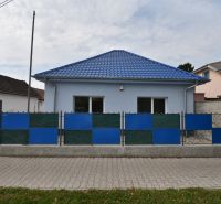 The exterior of commercial premises on Dlhoveská Street in Šaľa with a blue roof and fence.