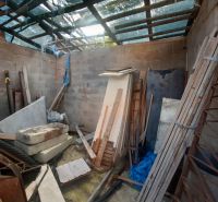 Building materials in an unfinished room of a family house with a roof structure.