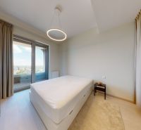 Bedroom with a large window, curtains, and a bed, 2-room apartment. Floor with wood decor.
