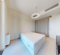 Bedroom with a bed and a nightstand, floor with wood decor, 2-room apartment.