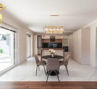 Family house with a dining area, kitchen, and wooden decor flooring.