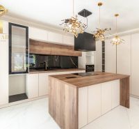 A kitchen with an island and a wooden decor floor in a family house.